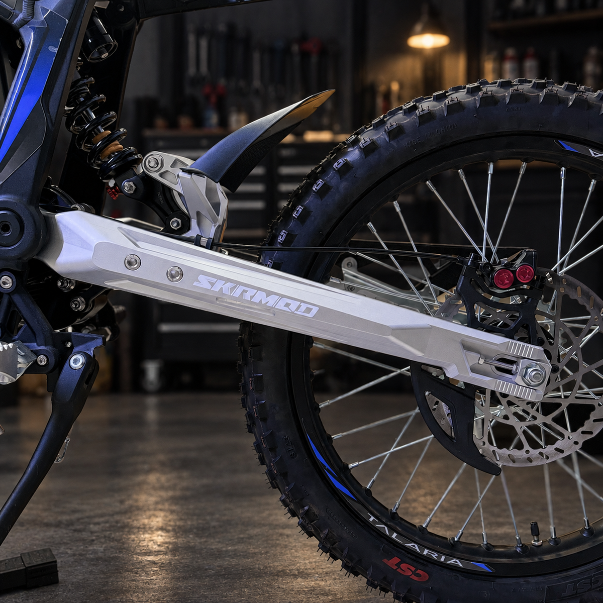 SKRMOD Talaria Sting R 50mm extended swingarm installed rear wheel detail